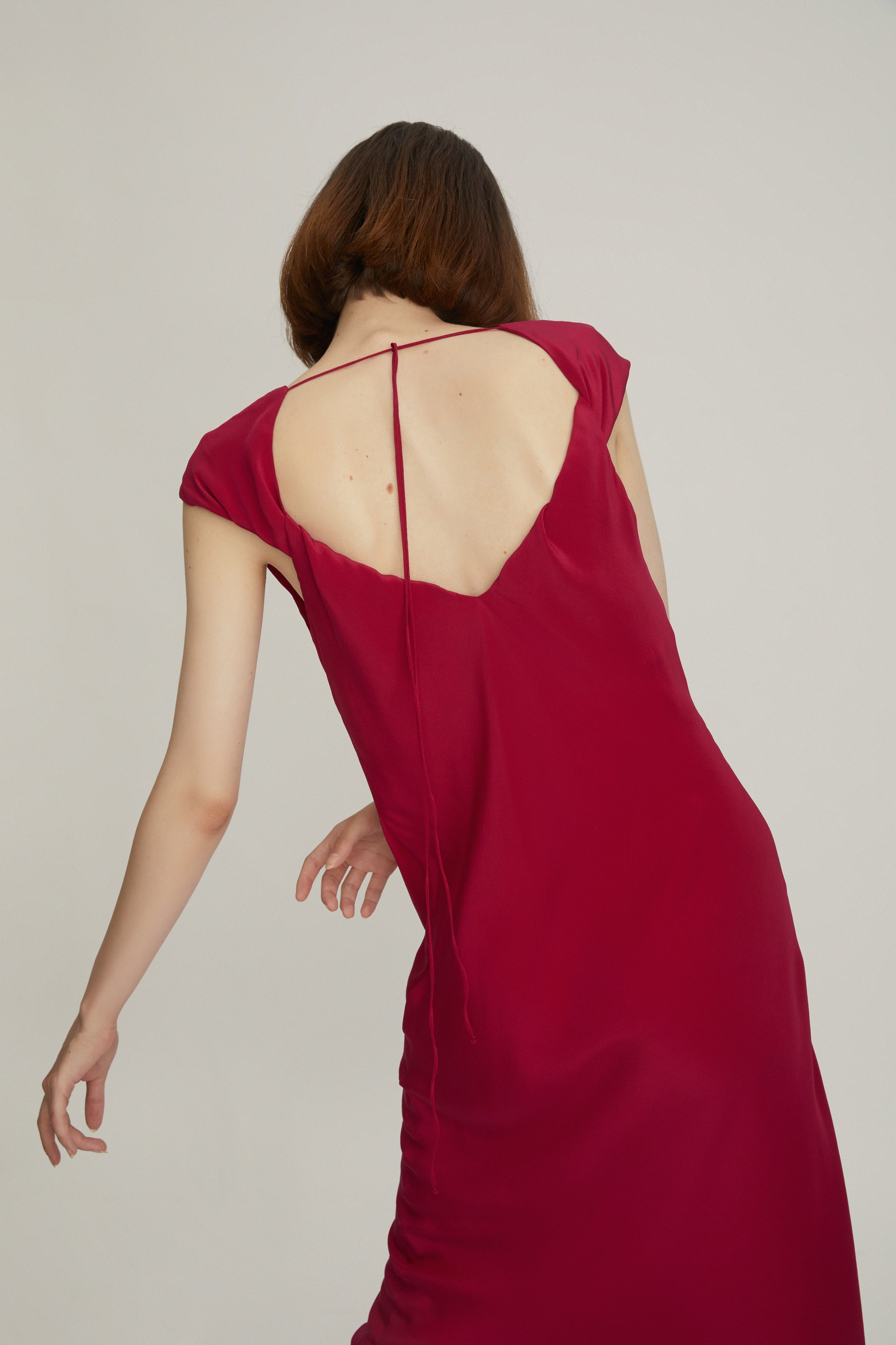 The Popping Pink Silk dress is a lightweight, slip-on style that slightly flares towards the hem for a clean silhouette.   Made from fluid 100% silk with a smooth quality, this slip dress is designed with an elegant deep V-neck.The twisted back detail was added as a statement to a polished look. 